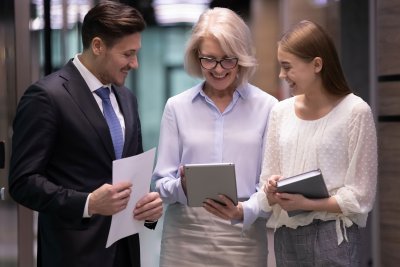 Three business people conversing in the hallway