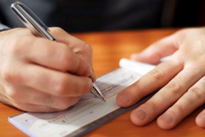 man writing a check