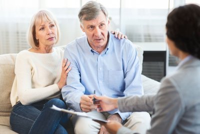 Mature couple signing documents